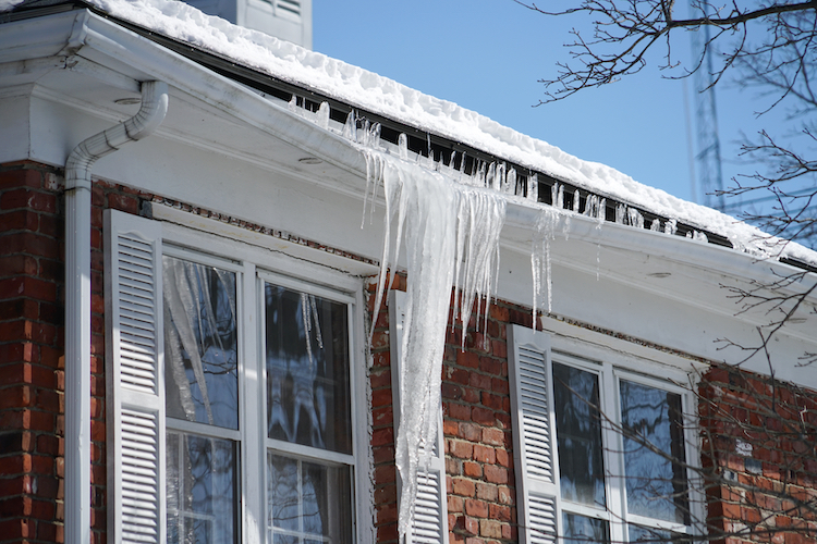 Ice Dams and Icicles Forming on The Gutters of a House | K-Guard St. Louis